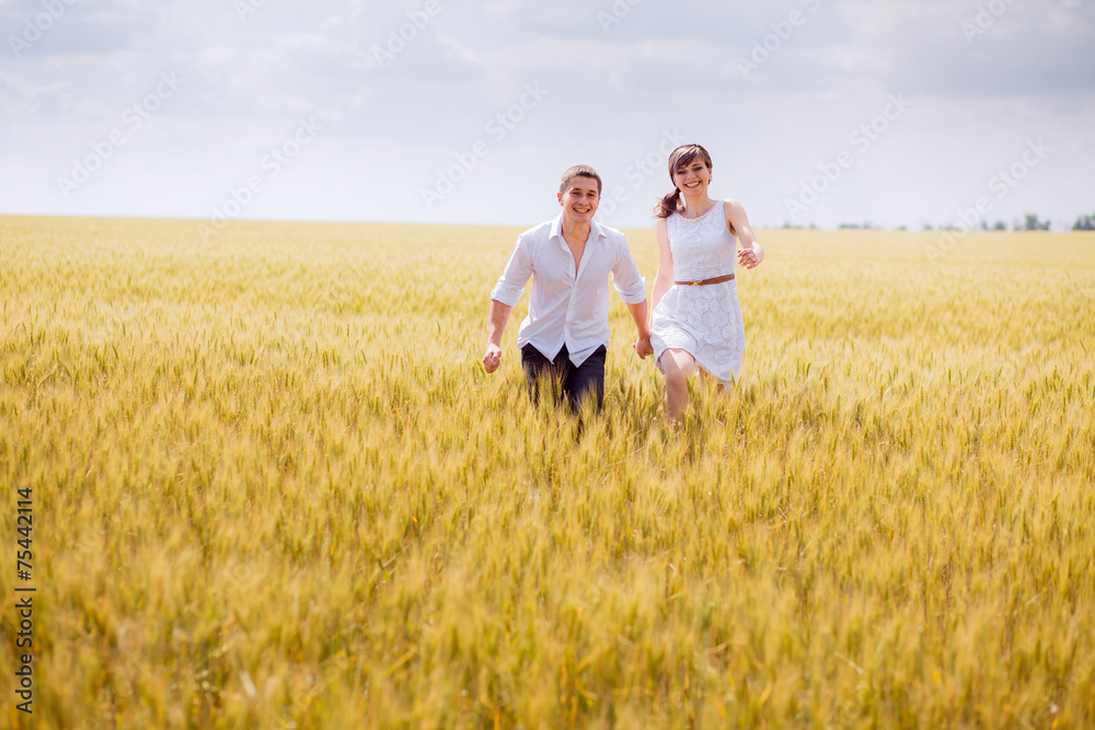 series. a love story. couple runs in the wheat field and smiling series. a love story. couple runs in the wheat field and smiling