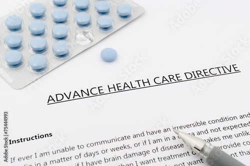 advance health care directive with blue pills ans grey pen photo