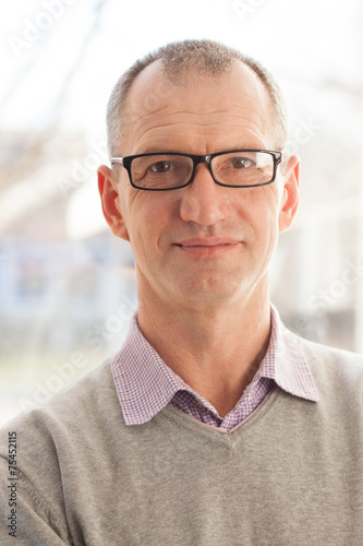 Closeup portrait of casual style adult man in glasses