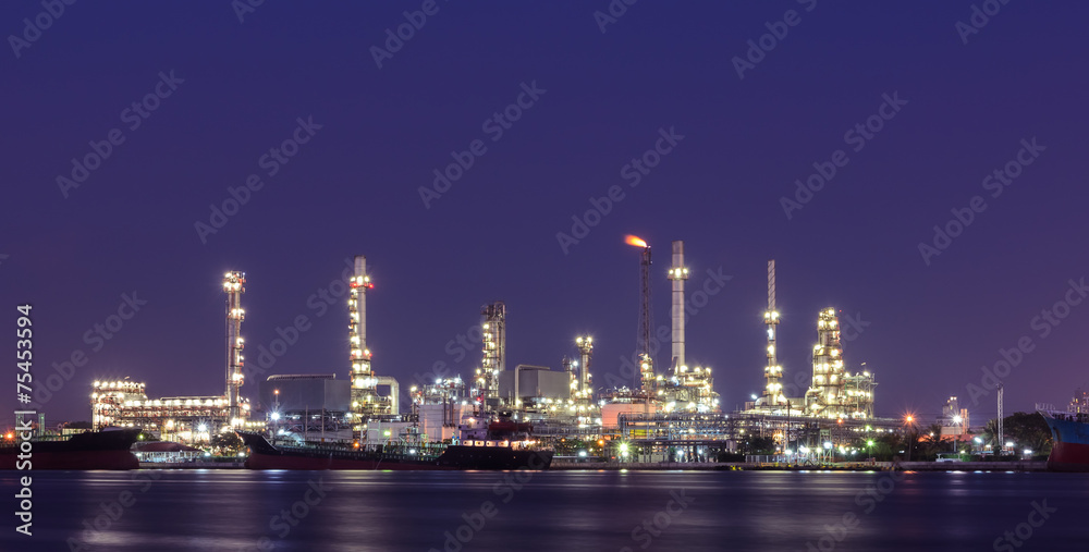 Oil refinery plant illuminated at twilight