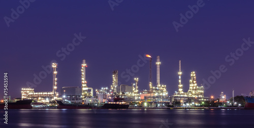 Oil refinery plant illuminated at twilight
