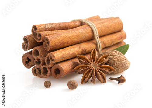 cinnamon sticks, anise star and spices on white