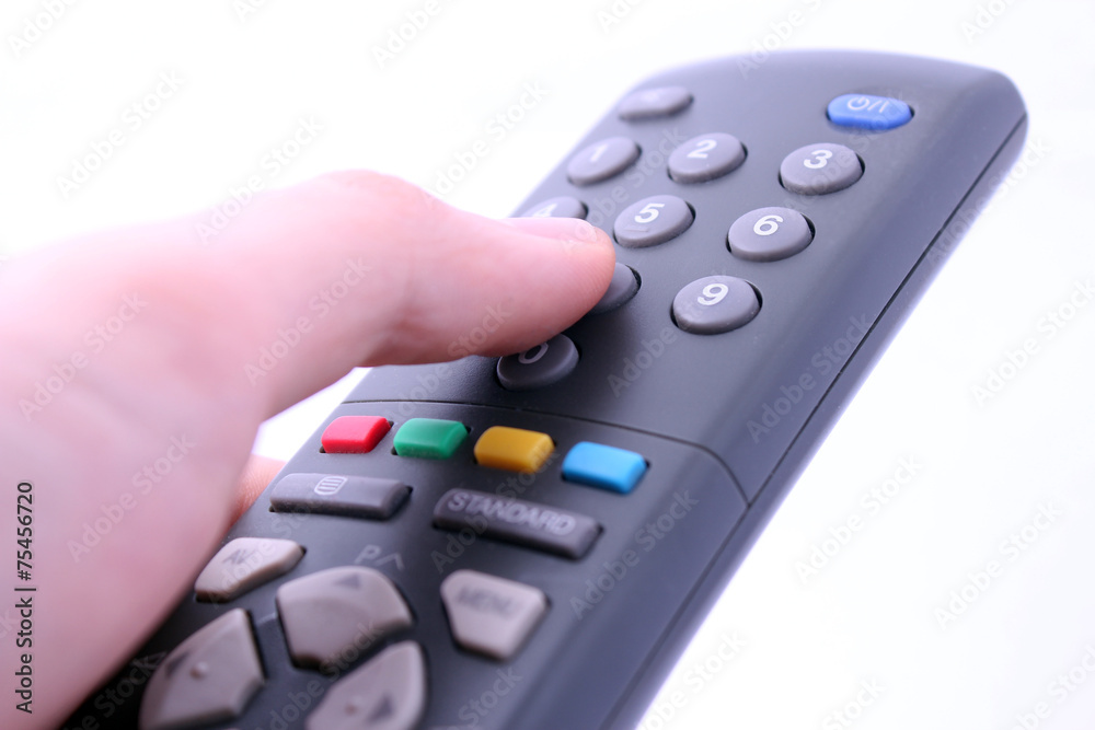 Hand pressing remote control button isolated on white background Hand pressing remote control button isolated on white background