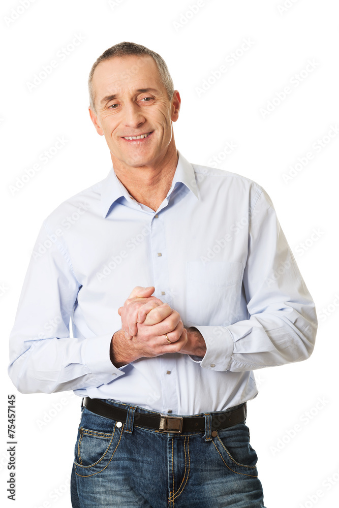 Happy handsome man with clenched hands Happy handsome man with clenched hands