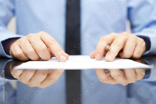 businessman is carefully reading contract