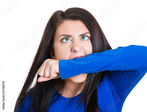 crazy, angry, looney young business woman biting her hand 