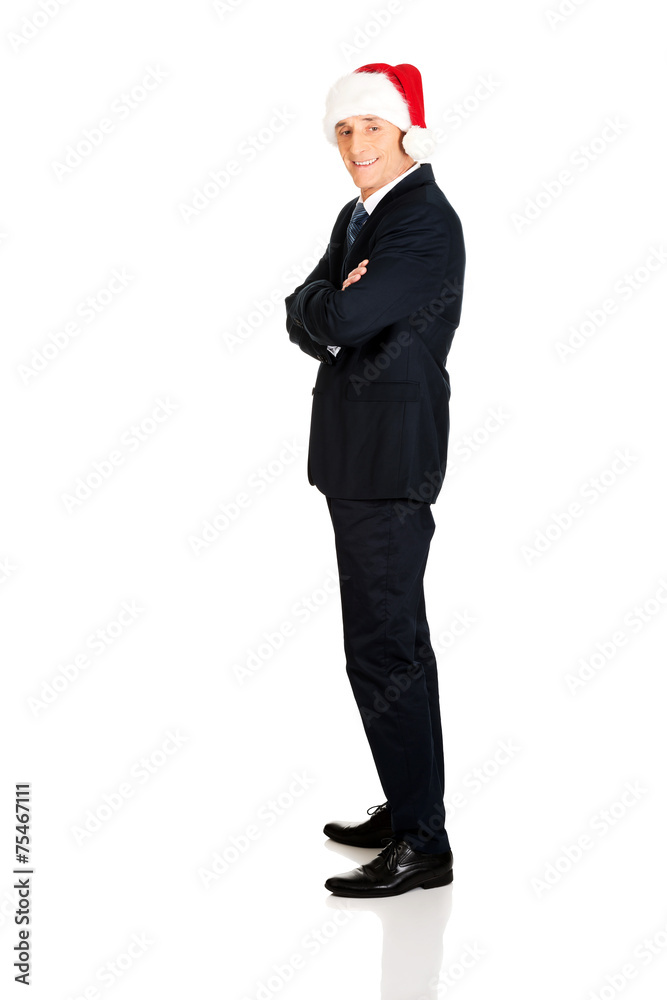 Side view man with folded arms wearing santa hat Side view man with folded arms wearing santa hat