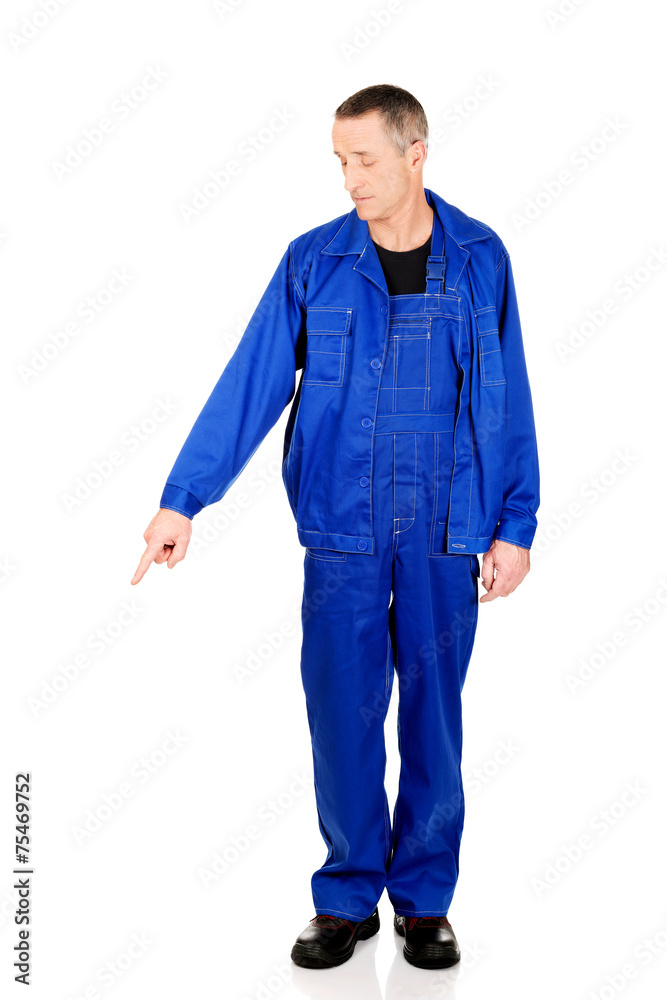 Full length repairman pointing down Full length repairman pointing down
