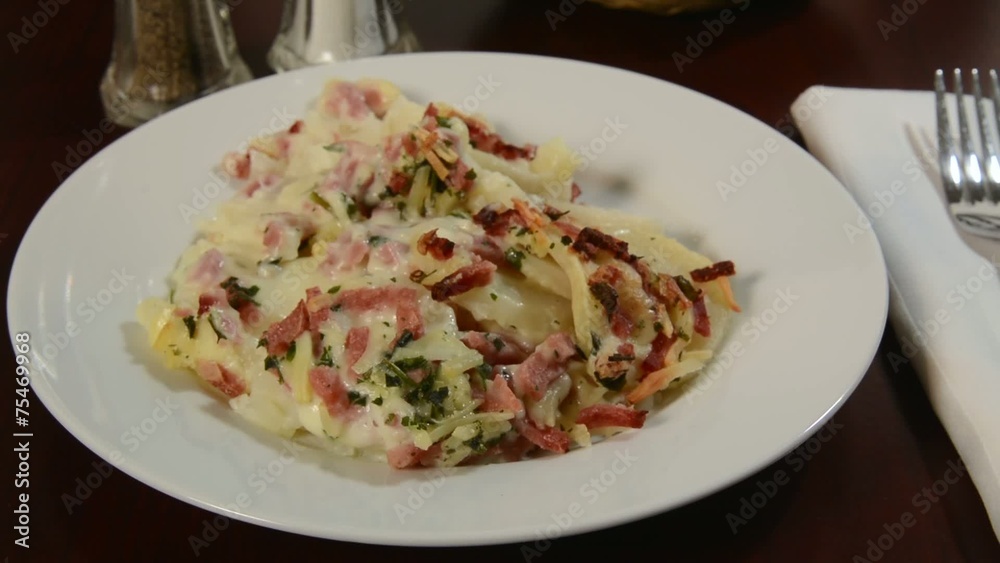Plate of Scalloped potatoes being served Plate of Scalloped potatoes being served