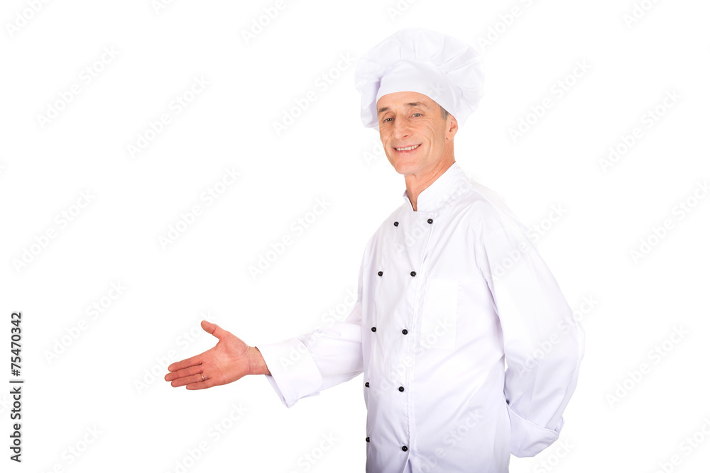 Mature chef showing copyspace on the left Mature chef showing copyspace on the left