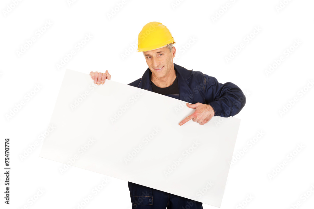 Happy worker presenting empty banner Happy worker presenting empty banner
