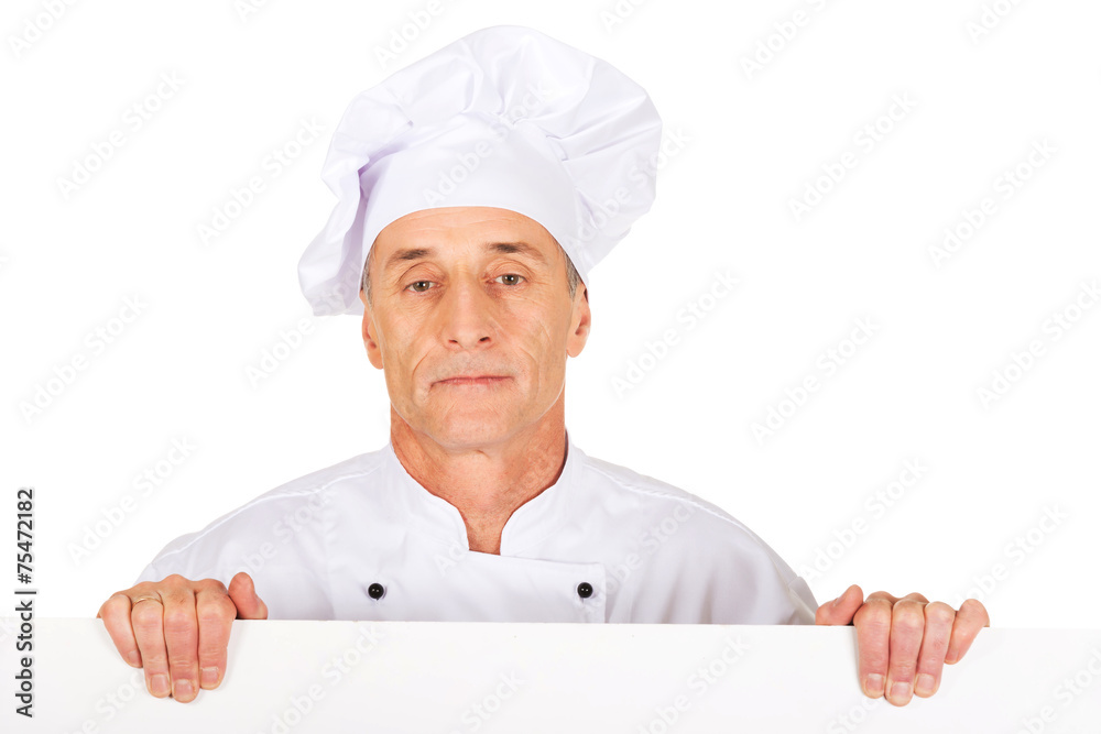 Chef in white uniform holding empty banner Chef in white uniform holding empty banner