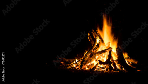 Obraz na plátně Night campfire with available space at left side.