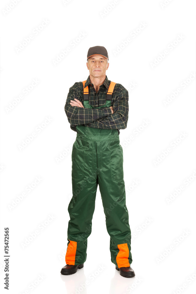 Mature gardener standing with folded arms Mature gardener standing with folded arms