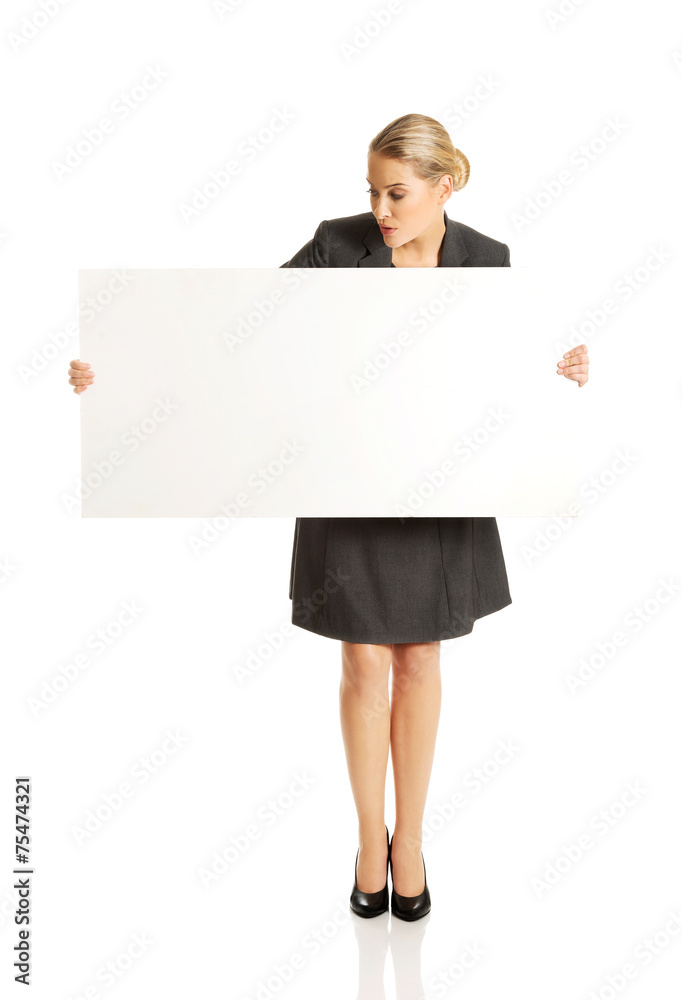 Businesswoman holding empty billboard Businesswoman holding empty billboard