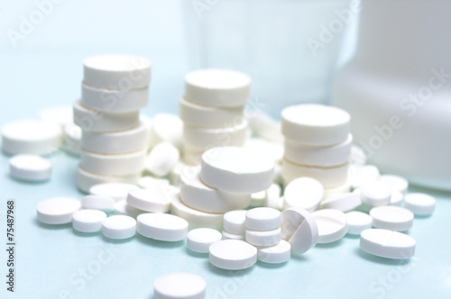 many different size white tablets stacked pile