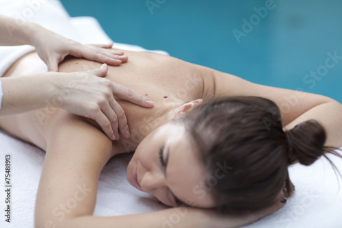 Young woman getting a massage in a spa 