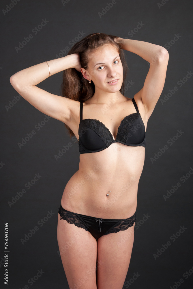 Fototapeta premium Positive slender graceful girl in lingerie