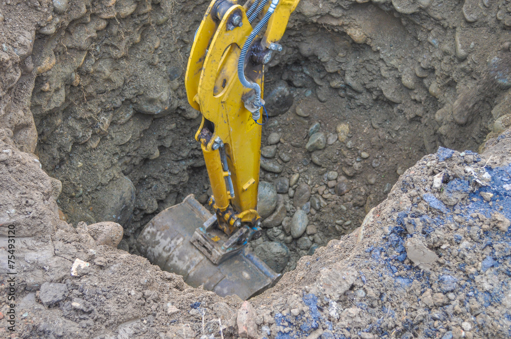 Excavator digging a hole