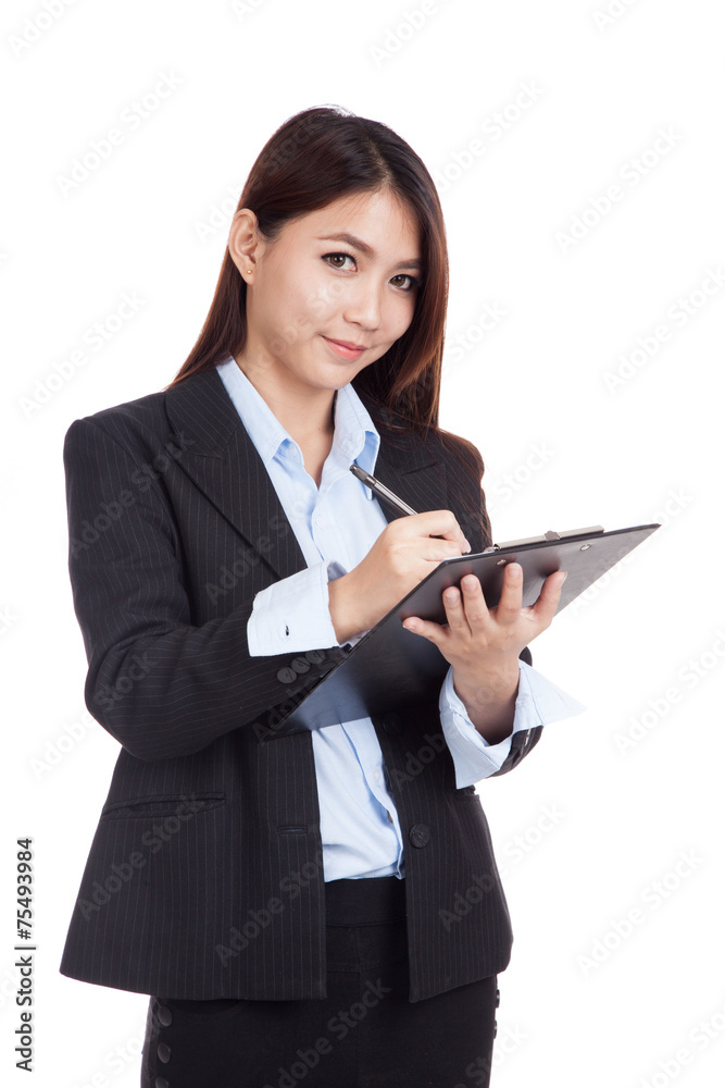 Young Asian businesswoman write on clipboard Young Asian businesswoman write on clipboard