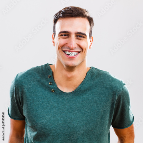Portrait of young man with braces photo