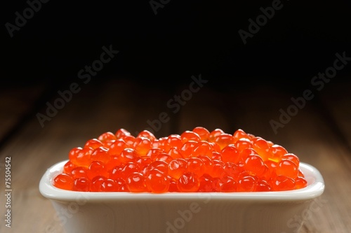 Red caviar in white bowl closep