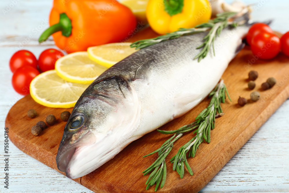 Fresh raw fish and food ingredients on table Fresh raw fish and food ingredients on table