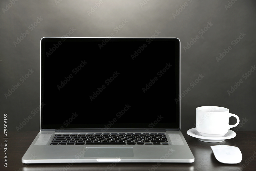 Fototapeta premium Modern laptop on table, on grey background