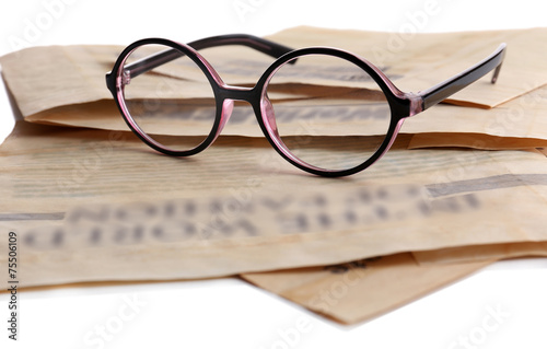 Glasses and newspapers, close-up