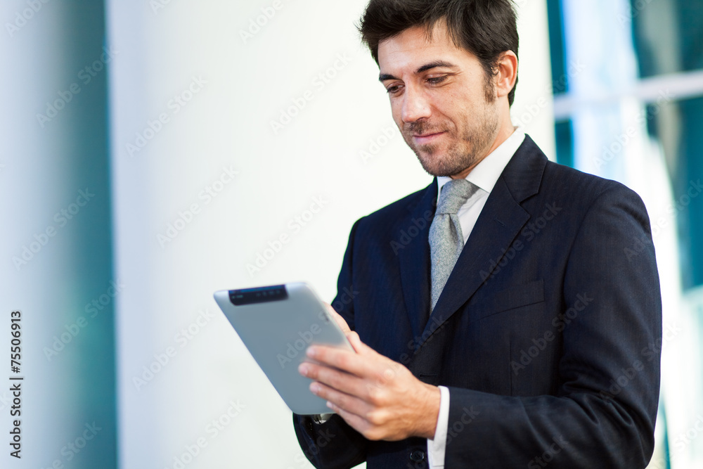Portrait of a smiling businessman using his tablet computer Portrait of a smiling businessman using his tablet computer