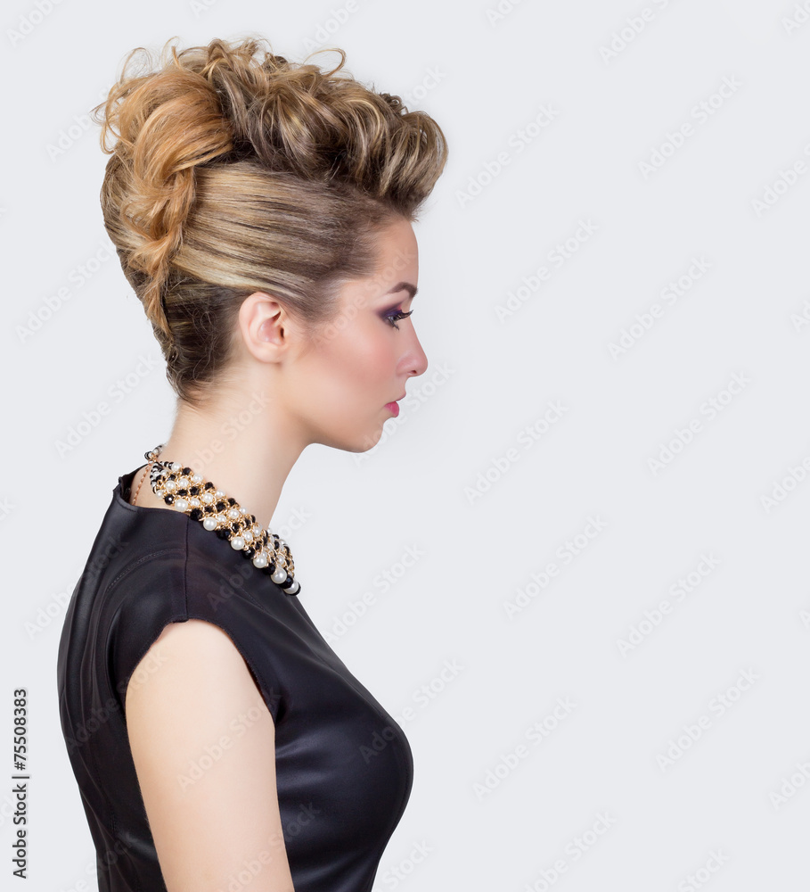Beautiful young woman with evening make-up and salon hairstyle