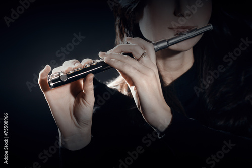 Flute piccolo with hands closeup photo