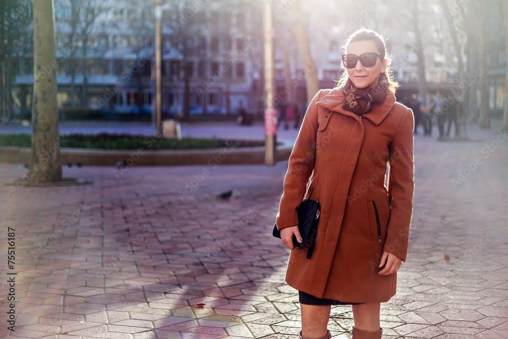 Fototapeta premium Girl standing and smiling in the city