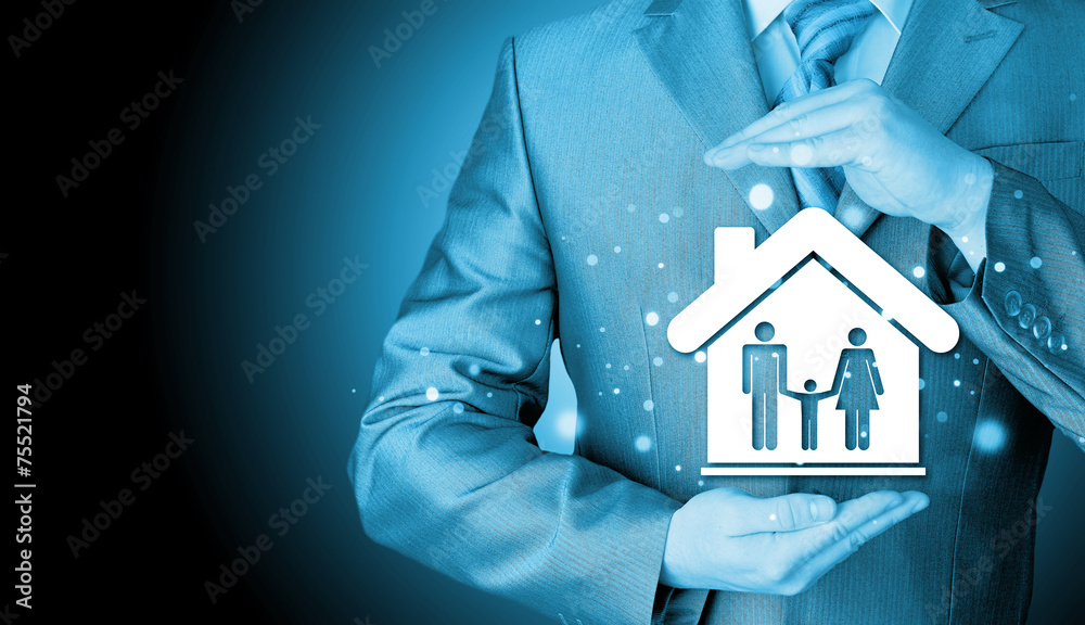 businessman protecting family in home with hands businessman protecting family in home with hands
