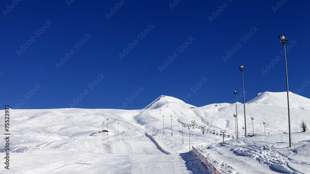 Winter mountains and ski slope at nice sun day
