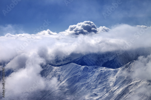 View on off-piste slope at mist and sunlight clouds © BSANI