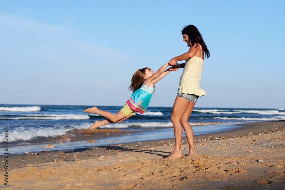 Fototapeta premium child swinging parent beach