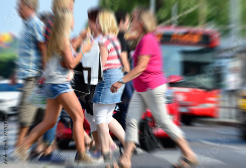Zoom blurred image of pedestrian crowd