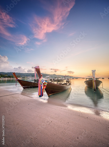 sunset with colorful sky and boat on the beach