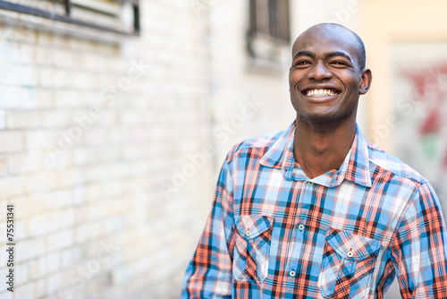 Black man wearing casual clothes in urban background photo