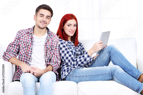Young couple sitting in sof...