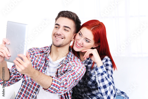 Young couple sitting in sof...