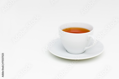 Classic white cup of black tea on white table