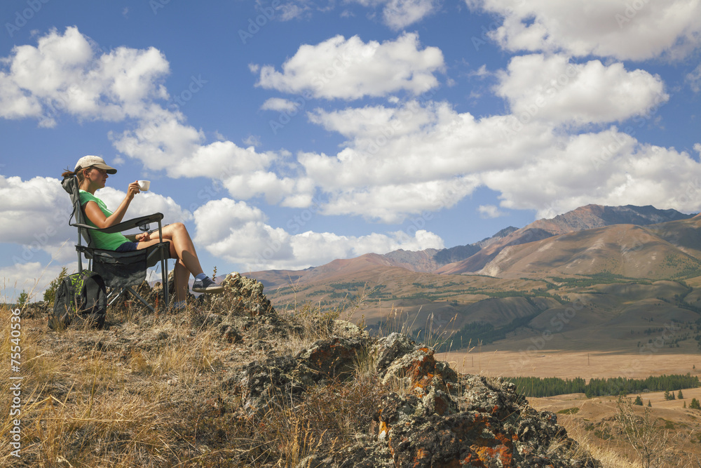 Happy tourist girl on the mountain