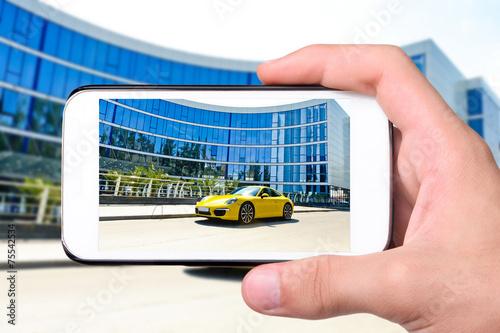 Hands taking photo car with smartphone