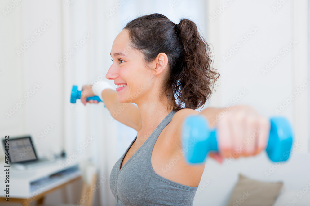 Young attractive girl doing exercise at home Young attractive girl doing exercise at home