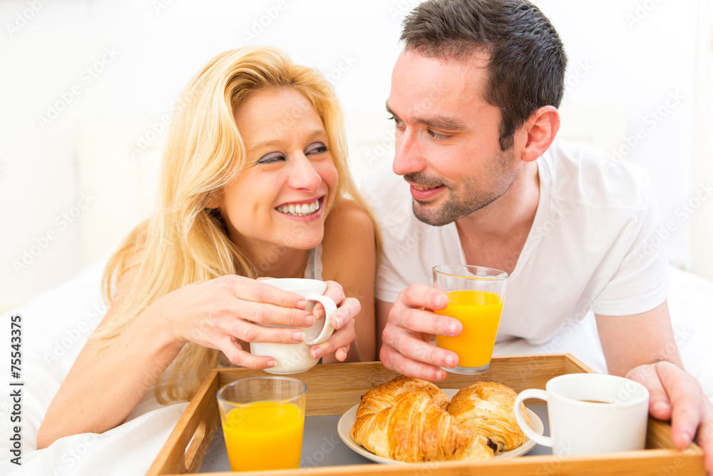 Portrait of a couple having breakfast in bed Portrait of a couple having breakfast in bed