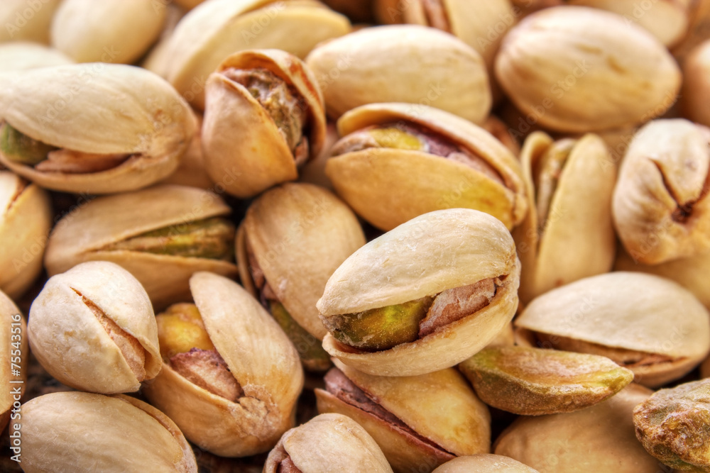 Salted and roasted pistachio nuts background Salted and roasted pistachio nuts background