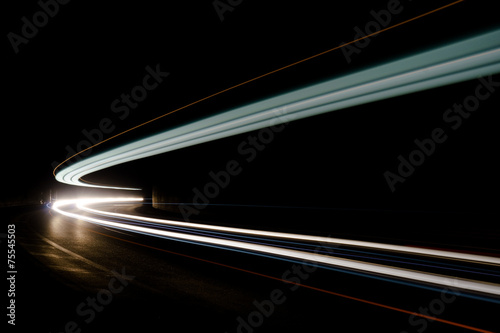 Abstract blue, yellow and white rays of light in a car tunnel