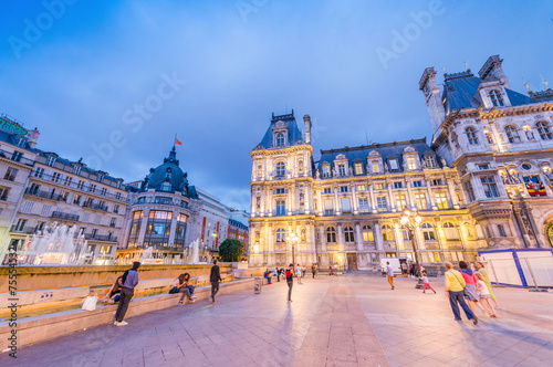 PARIS, FRANCE - JUNE 20, 2014: Tourists enjoy Hotel de Ville vie